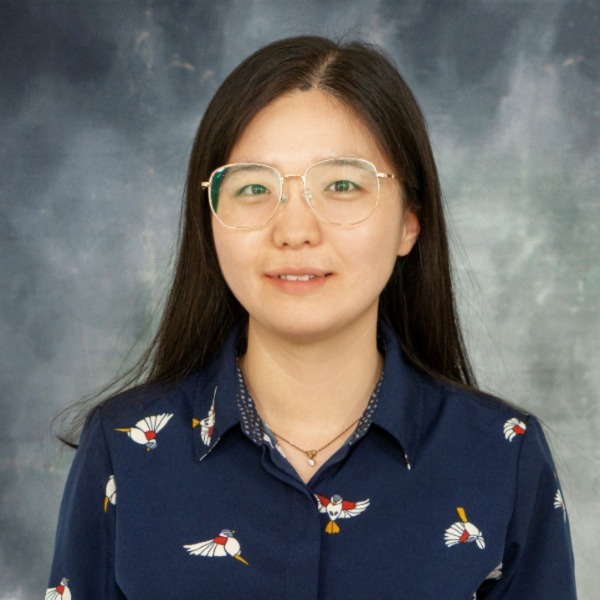 Professor Emma Zhang wears a navy shirt in her faculty profile