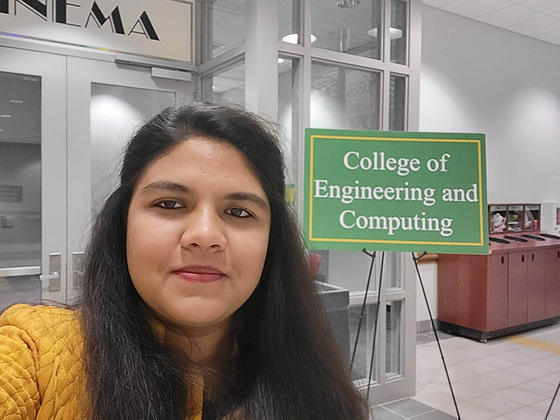 Rosy Sultana is shown next to a green sign that says College of Engineering and Computing