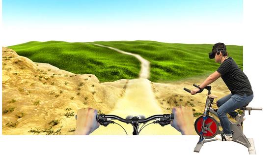 virtual reality scene of a bike path across bumpy terrain with an inset of a person on a stationary bike
