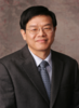 Mason Professor Inchi Hu wears a dark suit, blue tie and shirt, and glasses in his faculty profile