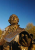A photo of the the bronze-colored George Mason statue 
