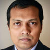 Tanvir Arafin wears a dark suit and blue shirt in his faculty profile for the Department of Cyber Security Engineering.