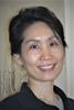Mason associate professor Liling Huang wears a black blouse and has her hair in a bun in her faculty profile