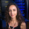Mason assistant professor Foteini Baldimtsi wears a black, sleeveless shirt, bright necklace and has curly brown hair