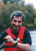James Baldo wears a red safety vest while canoeing on the river