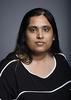 Mason assistant professor Pramita Bagchi wears a striped black and white blouse in her faculty profile