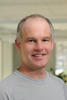 Mason associate professor Paul Ammann wears a gray shirt and has gray hair in his profile